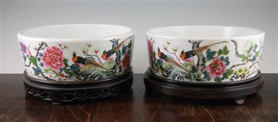 A pair of Chinese famille rose circular narcissus bowls, Qianlong marks, Republic period, 25cm, wood stands